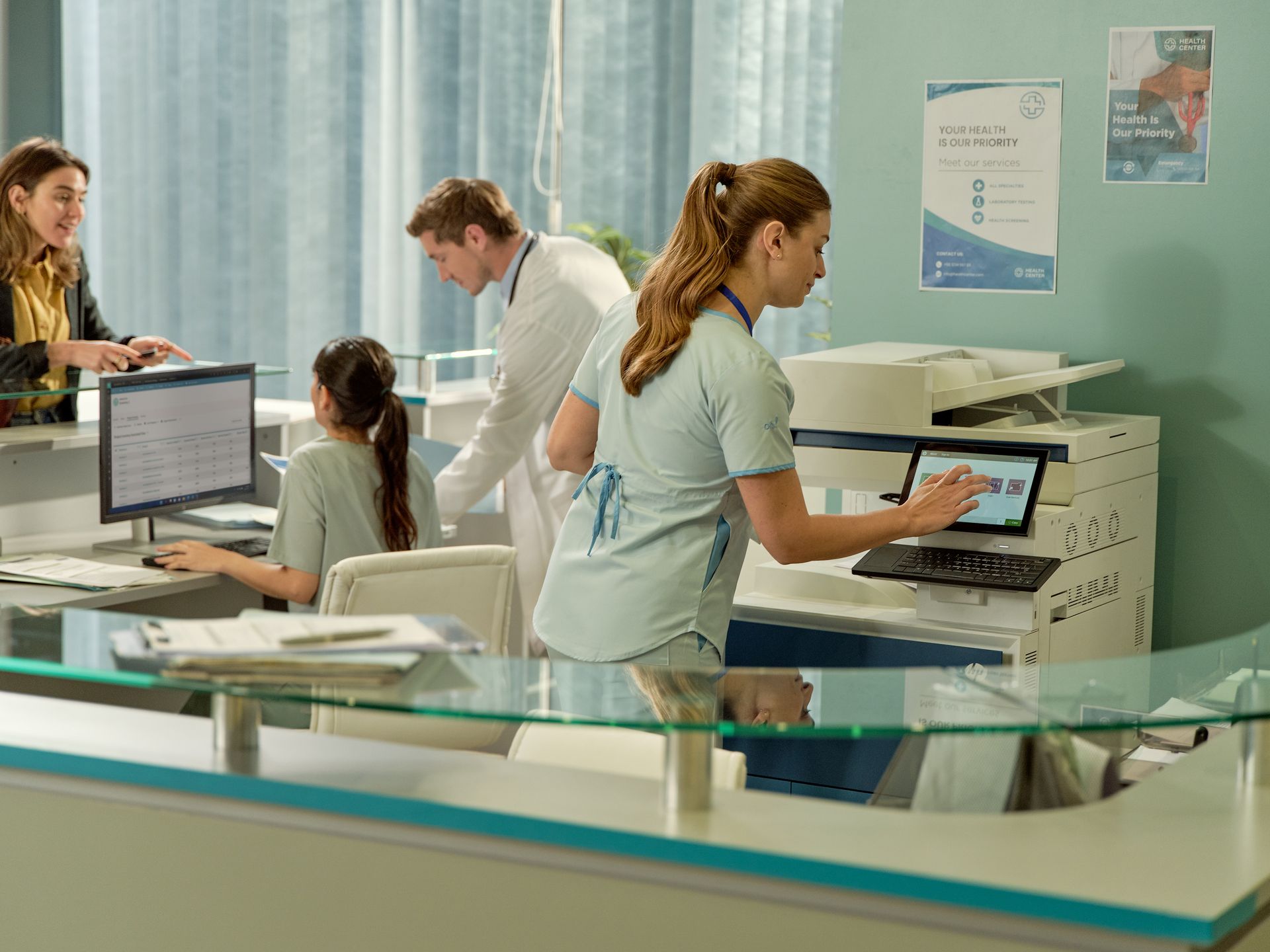 Clinic staff using an HP office multifunction printer